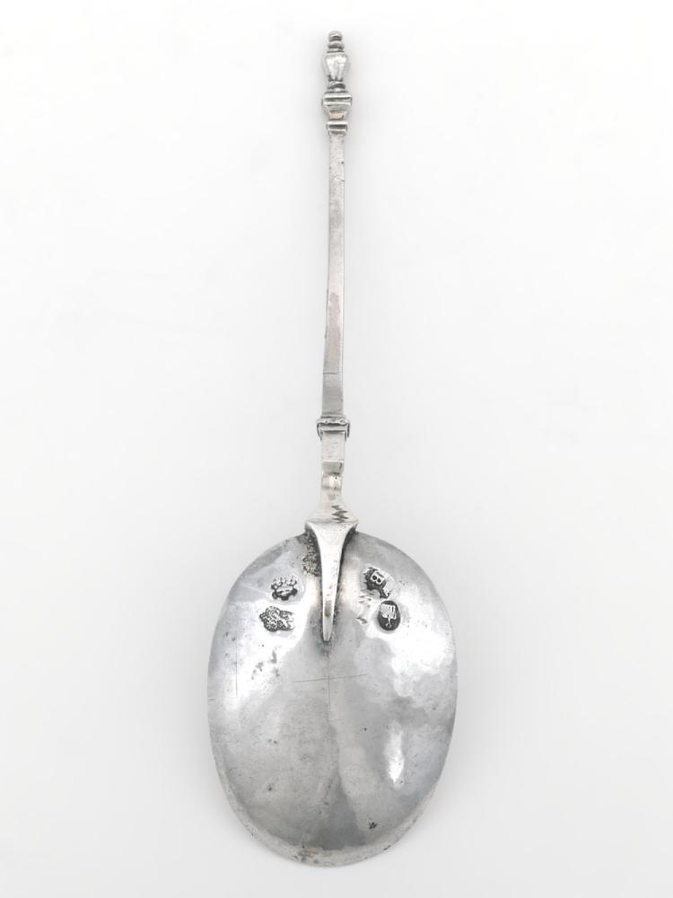 Lepel van zilver  ovale lepelbak en dunne balkvormige steel metknoop eindigend op balustervormige bekroning  17de eeuw